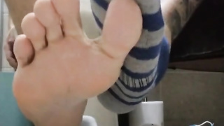 Stud in Douche Demonstrating his Soles and Socks