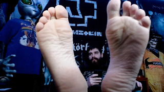 Bearded Metalhead Gamer Flashing Soles While Texting