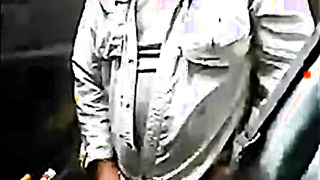 Bearded daddy strokes his cock by his truck outdoors.