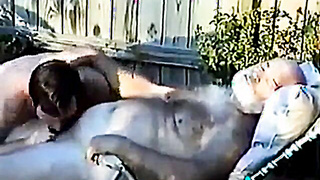 Young Boy Inhales Off a Fur covered Grandfather